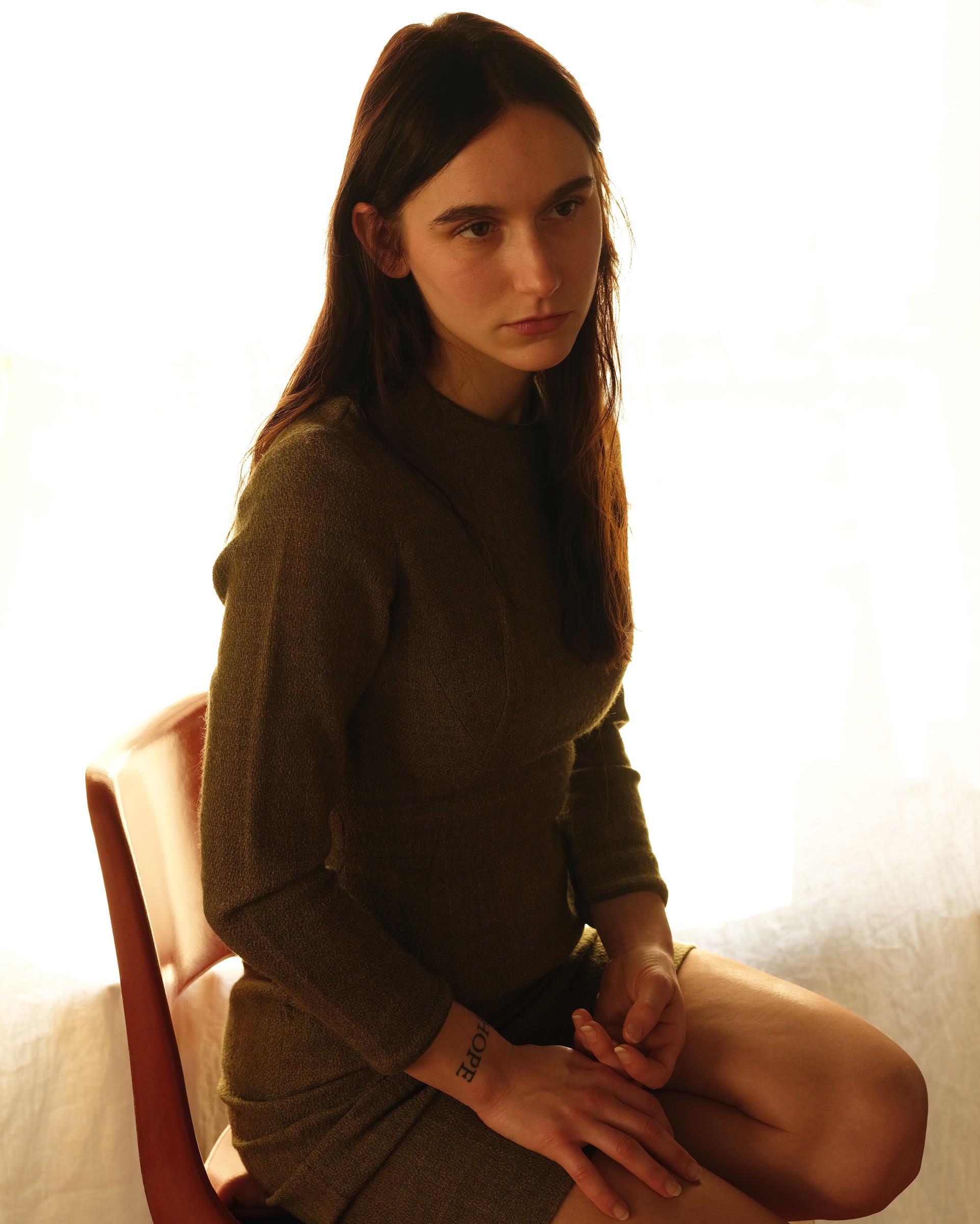 Ivy Knight seated in a warm backlit portrait